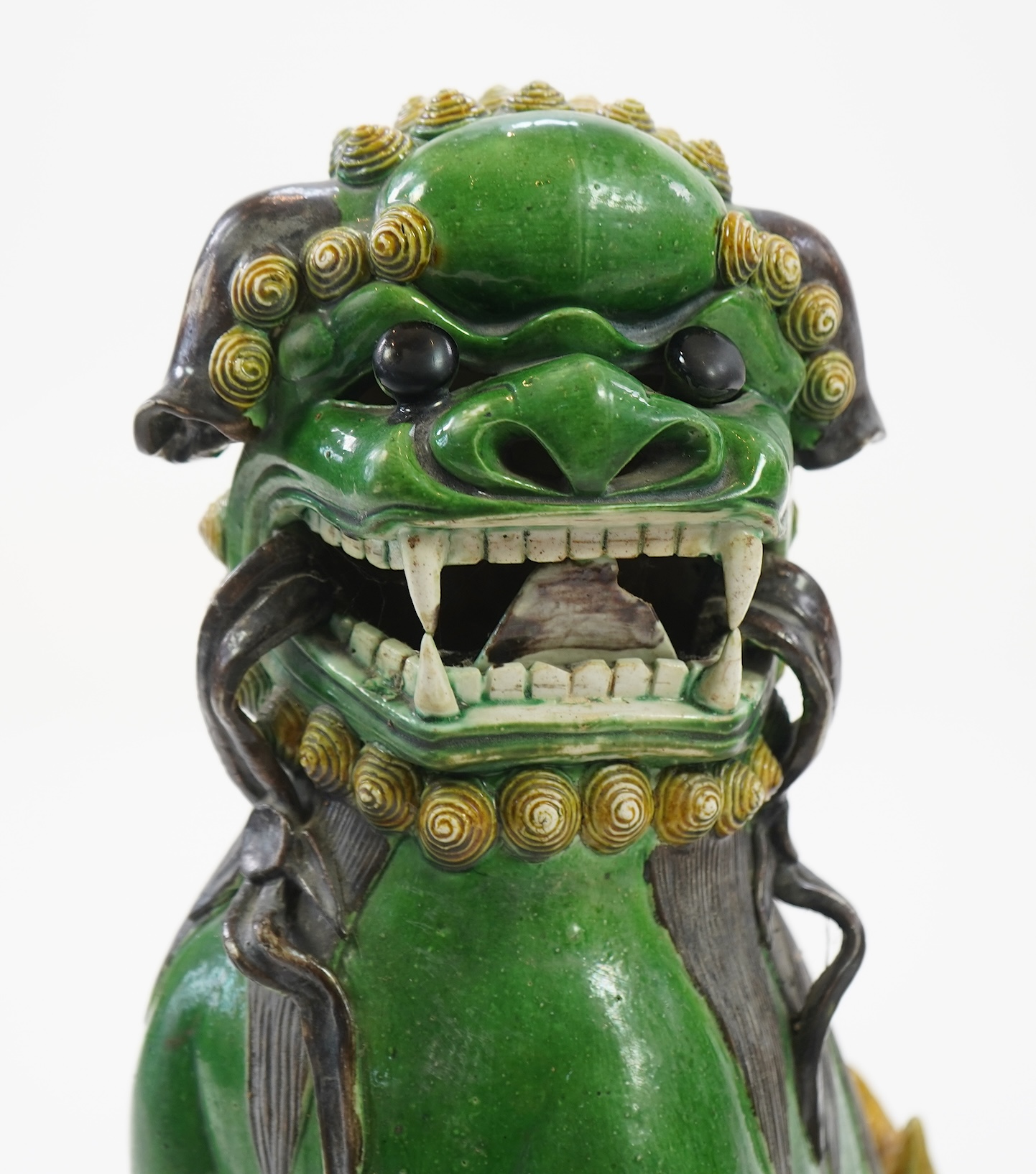 A pair of large Chinese sancai-glazed biscuit figures of Buddhist temple lions, 19th century
